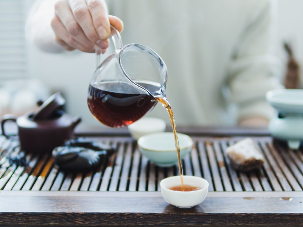 A fairness pitcher being used to pour tea